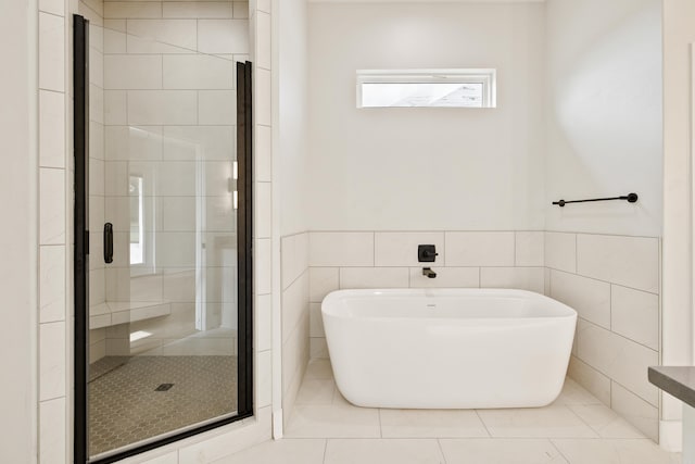 6172 Majestic Waters Dr, Alexander, AR 72002 - full bathroom with a freestanding tub, a stall shower, tile walls, wainscoting, and tile patterned flooring