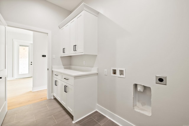 6172 Majestic Waters Dr, Alexander, AR 72002 - laundry area featuring electric dryer hookup, cabinet space, washer hookup, and baseboards