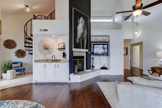 101 Long Island Dr Unit 605, Hot Springs, AR 71913 - living room featuring ceiling fan, dark wood finished floors, a towering ceiling, visible vents, and stairway