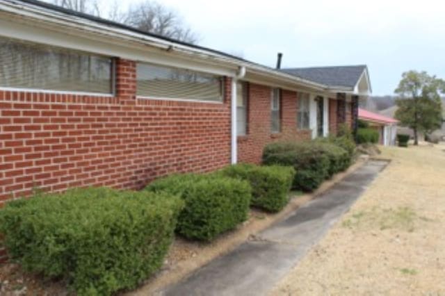 view of home's exterior with brick siding