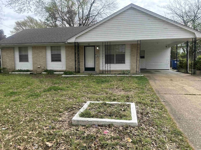 400 Oxford St, West Memphis, AR 72301 - view of front of house featuring a garden, brick siding, a front lawn, an attached carport, and driveway