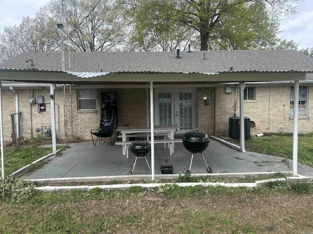 400 Oxford St, West Memphis, AR 72301 - rear view of house featuring brick siding, french doors, central AC unit, and a patio
