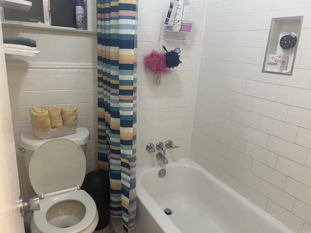 400 Oxford St, West Memphis, AR 72301 - full bath with shower / tub combo with curtain, wainscoting, tile walls, and toilet