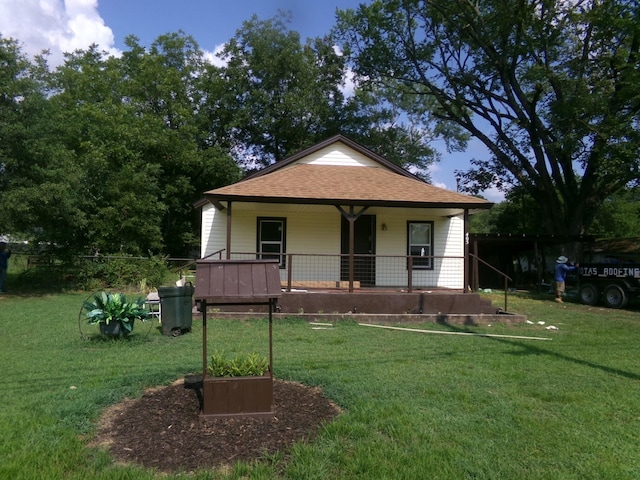 405 S Skaggs Rd, Clarksville, AR 72830 - bungalow featuring a porch, a front lawn, and roof with shingles