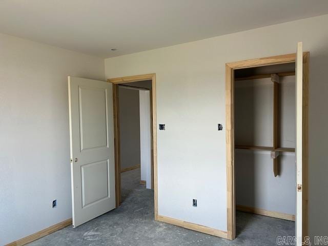 188 Kelton Ln, Hensley, AR 72065 - unfurnished bedroom with baseboards and concrete flooring