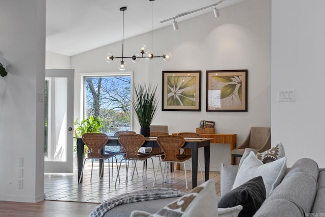 139 Sammie Cv, Hot Springs, AR 71913 - dining space featuring baseboards, an inviting chandelier, track lighting, lofted ceiling, and wood finished floors