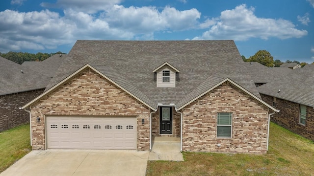 view of front of home featuring concrete driveway, a garage, a front lawn, and brick siding