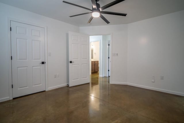 unfurnished bedroom featuring concrete floors, ceiling fan, and baseboards