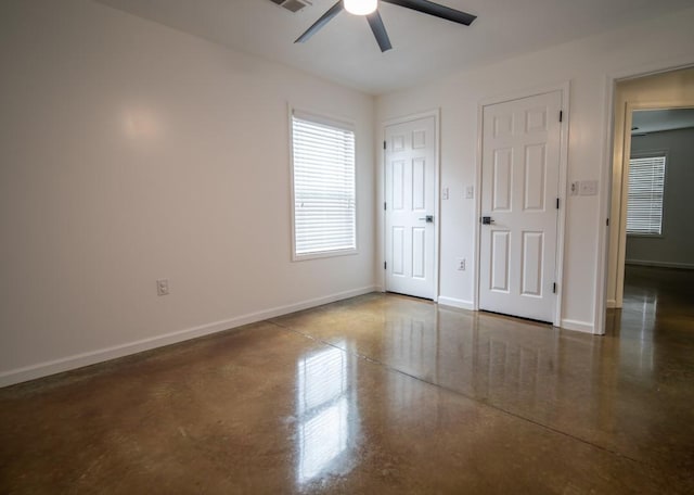 unfurnished bedroom featuring visible vents, baseboards, and finished concrete flooring