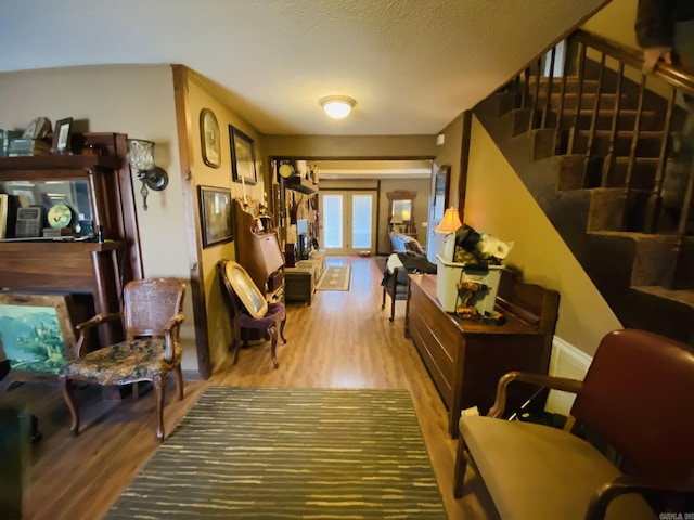 interior space with stairway, french doors, and wood finished floors