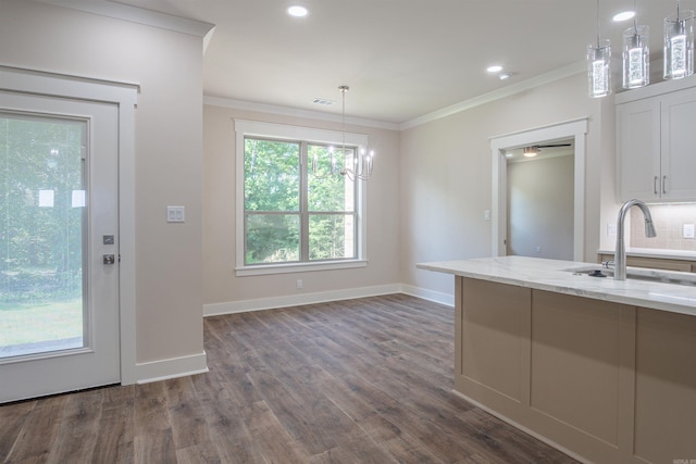 228 Michelle Dr, Beebe, AR 72012 - kitchen featuring a sink, light stone countertops, ornamental molding, dark wood-style flooring, and decorative light fixtures