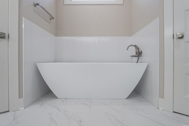 228 Michelle Dr, Beebe, AR 72012 - bathroom featuring marble finish flooring, a soaking tub, and a wainscoted wall