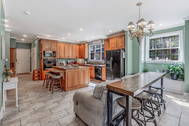kitchen featuring a kitchen breakfast bar, an inviting chandelier, a kitchen island, brown cabinetry, and black appliances