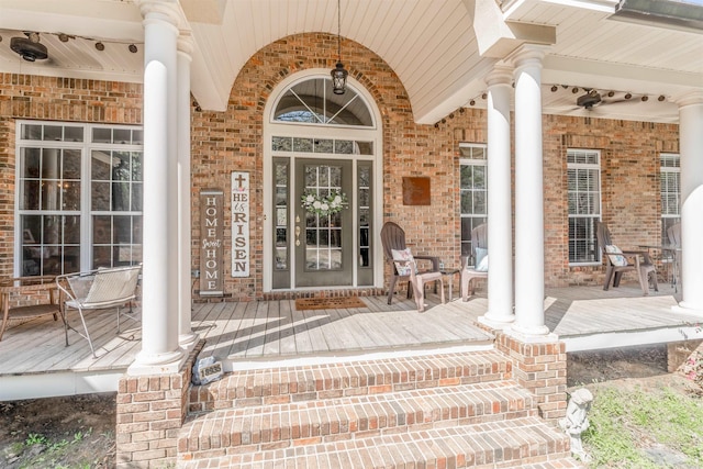 property entrance featuring brick siding and covered porch