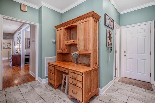 office space with visible vents, baseboards, and crown molding