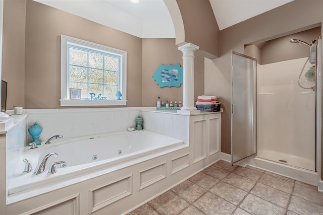 bathroom featuring decorative columns, vaulted ceiling, a stall shower, and a tub with jets