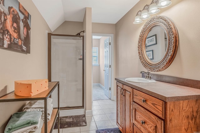 bathroom with tile patterned flooring, a stall shower, vaulted ceiling, and vanity