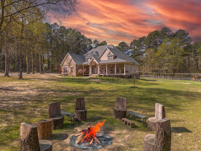 exterior space with an outdoor fire pit and fence