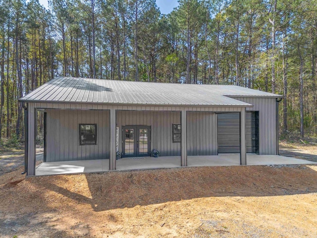 exterior space with metal roof and french doors