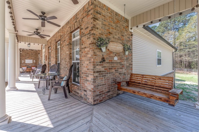 wooden terrace with a ceiling fan
