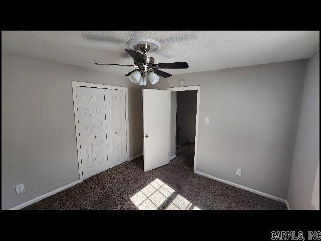 5507 Southboro Ct, Little Rock, AR 72209 - unfurnished bedroom featuring a closet, ceiling fan, carpet, and a textured ceiling
