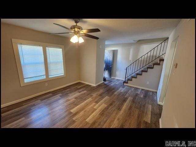 5507 Southboro Ct, Little Rock, AR 72209 - unfurnished living room featuring baseboards, stairway, wood finished floors, and a ceiling fan
