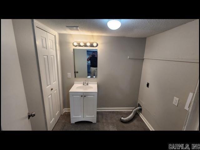 5507 Southboro Ct, Little Rock, AR 72209 - bathroom featuring a textured ceiling, vanity, and baseboards
