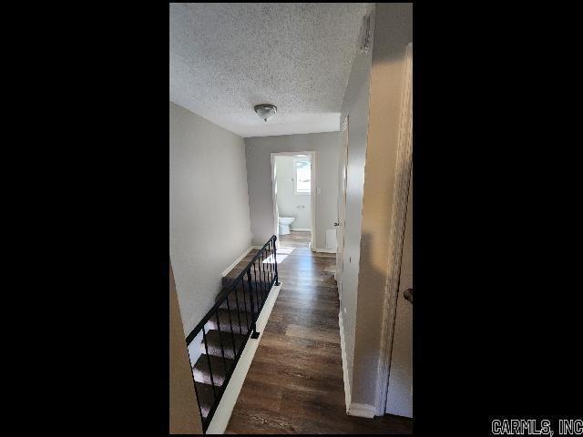 5507 Southboro Ct, Little Rock, AR 72209 - corridor with an upstairs landing, wood finished floors, and a textured ceiling