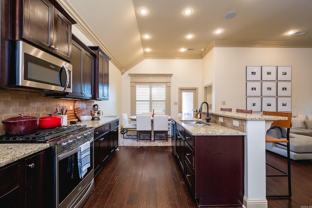 3 Commentry Dr, Little Rock, AR 72223 - kitchen featuring a sink, appliances with stainless steel finishes, a kitchen breakfast bar, dark wood-style floors, and backsplash