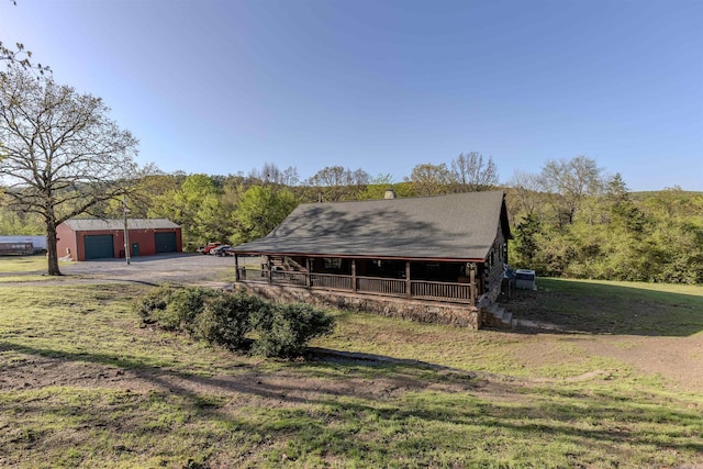 208 Mountain Dr, Perryville, AR 72126 - exterior space featuring aphalt driveway, a forest view, an outbuilding, and covered porch