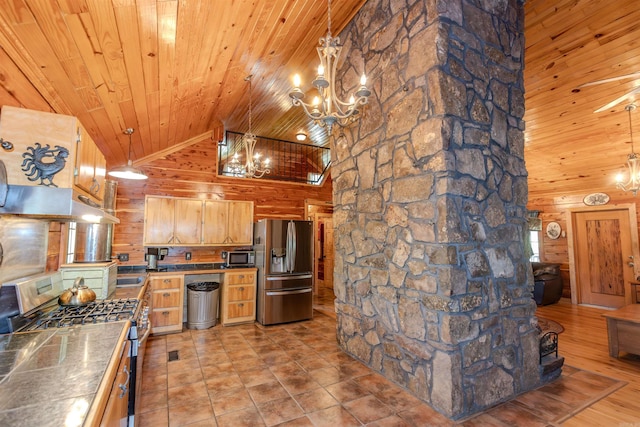 208 Mountain Dr, Perryville, AR 72126 - kitchen featuring a chandelier, wood ceiling, wooden walls, under cabinet range hood, and stainless steel appliances