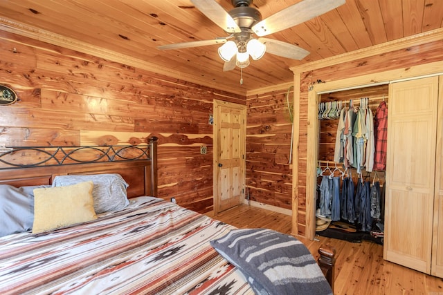 208 Mountain Dr, Perryville, AR 72126 - bedroom featuring a closet, a ceiling fan, wood ceiling, wood finished floors, and wooden walls