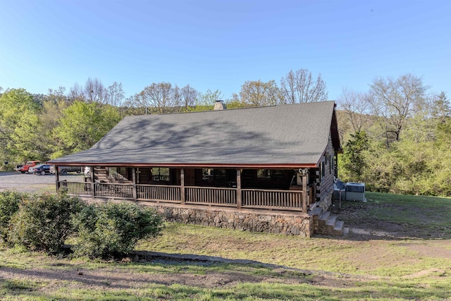 208 Mountain Dr, Perryville, AR 72126 - country-style home with a porch, roof with shingles, a chimney, and log siding