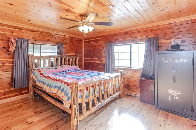 208 Mountain Dr, Perryville, AR 72126 - bedroom with wooden walls, light wood-style floors, and multiple windows