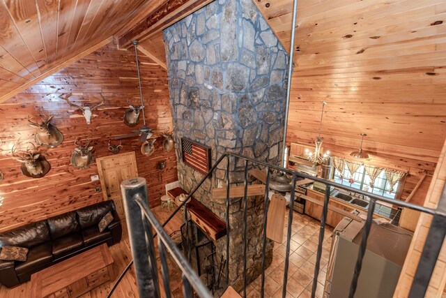 208 Mountain Dr, Perryville, AR 72126 - stairway featuring wood walls, vaulted ceiling with beams, wooden ceiling, and tile patterned flooring