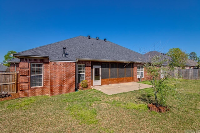 back of property featuring a yard, a fenced backyard, a patio, brick siding, and a shingled roof