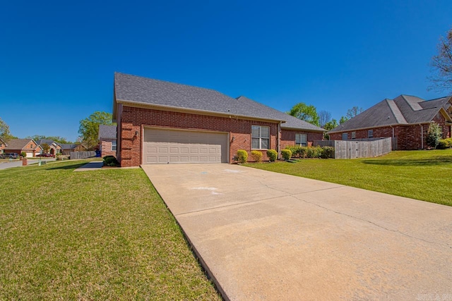 ranch-style home with a garage, fence, a front lawn, brick siding, and concrete driveway
