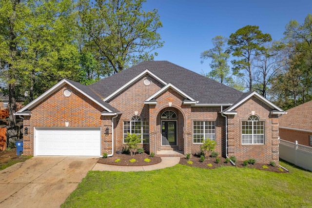 view of front of home with a front yard, fence, brick siding, an attached garage, and concrete driveway