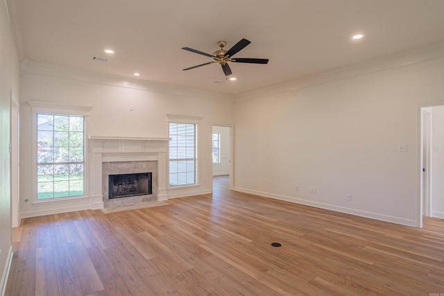 unfurnished living room with light wood finished floors, visible vents, crown molding, and a ceiling fan