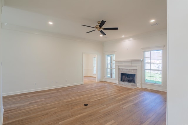 unfurnished living room with baseboards, light wood-type flooring, recessed lighting, crown molding, and a ceiling fan