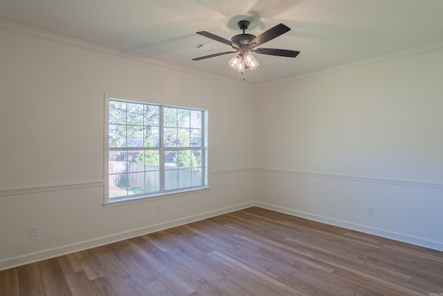 unfurnished room featuring baseboards, ornamental molding, a ceiling fan, and wood finished floors
