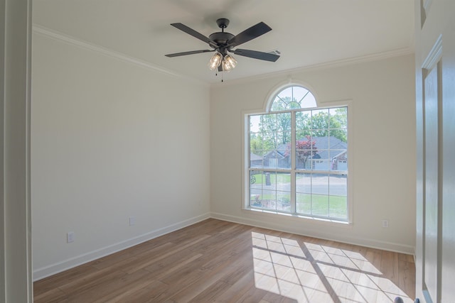 unfurnished room featuring light wood-style flooring, baseboards, and ornamental molding