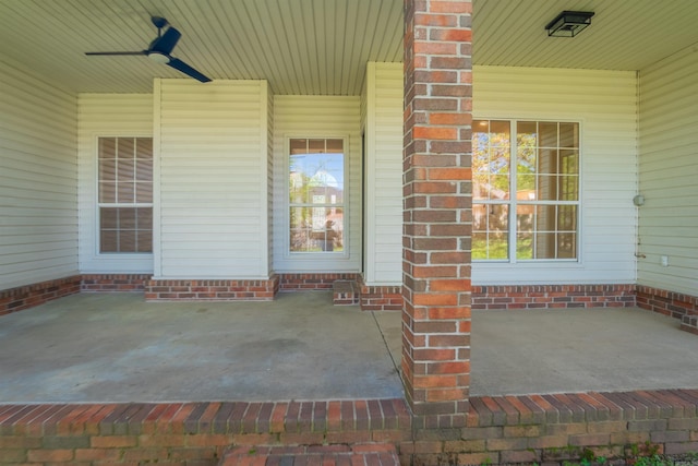 doorway to property with ceiling fan and a porch
