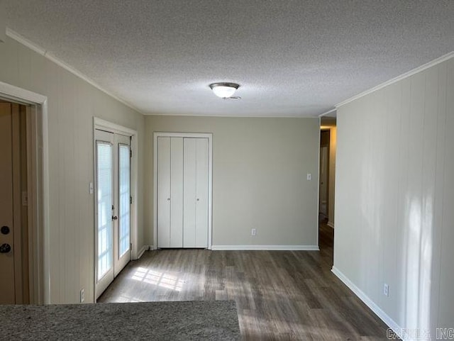 unfurnished bedroom with french doors, crown molding, wood finished floors, and a textured ceiling