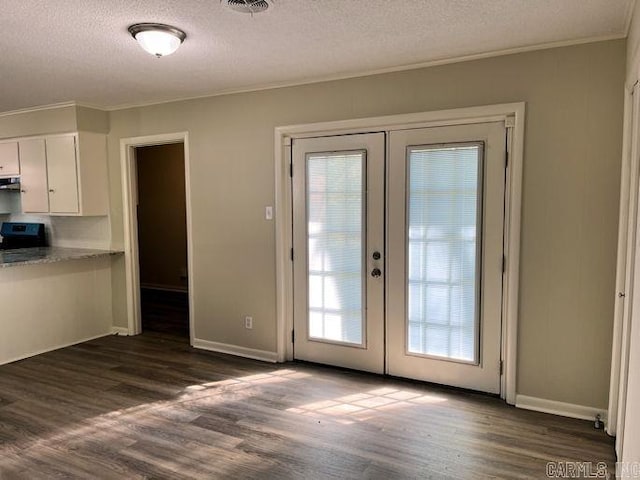 doorway to outside with a textured ceiling, french doors, ornamental molding, and dark wood finished floors