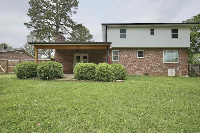 102 Windsor Pl, Hot Springs, AR 71901 - rear view of house featuring fence, a chimney, a yard, and brick siding