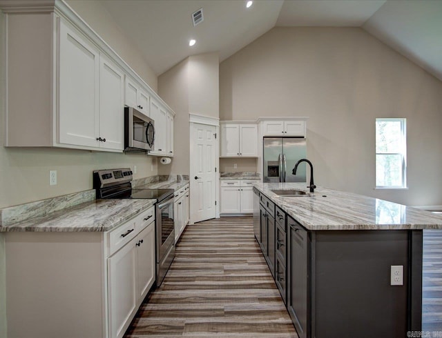 341 Diamondhead Dr, Hot Springs, AR 71913 - kitchen with light stone counters, white cabinetry, a center island with sink, appliances with stainless steel finishes, and a sink