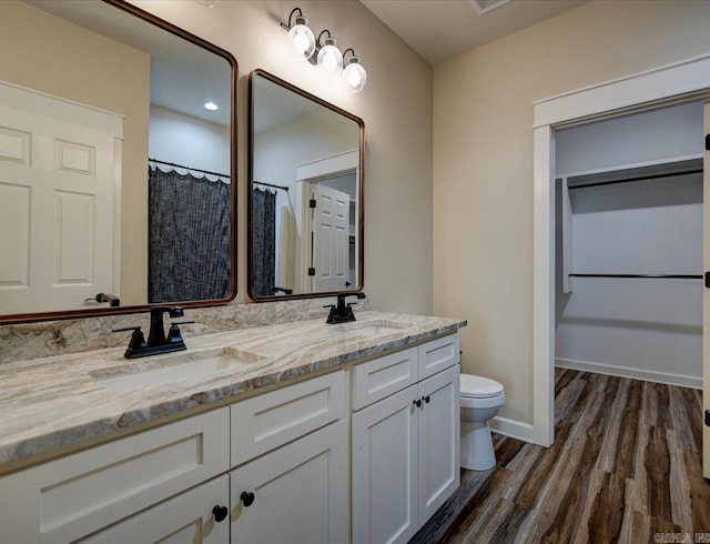 341 Diamondhead Dr, Hot Springs, AR 71913 - bathroom with toilet, wood finished floors, double vanity, and a sink