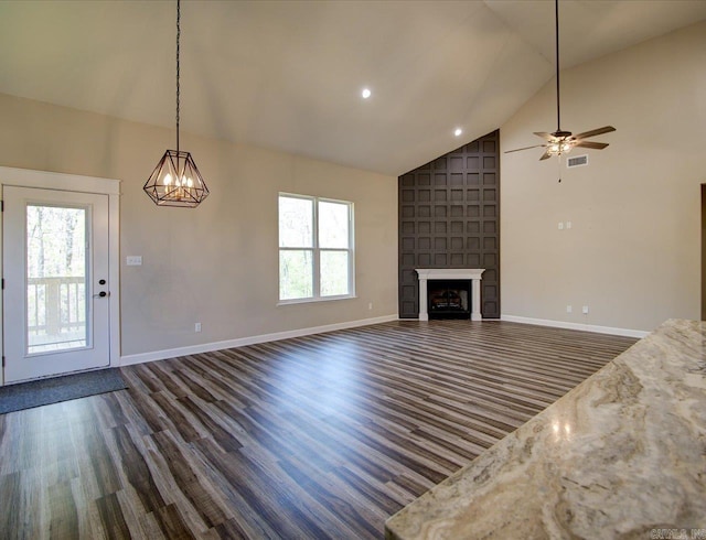 341 Diamondhead Dr, Hot Springs, AR 71913 - unfurnished living room featuring baseboards, a fireplace, dark wood finished floors, high vaulted ceiling, and ceiling fan with notable chandelier