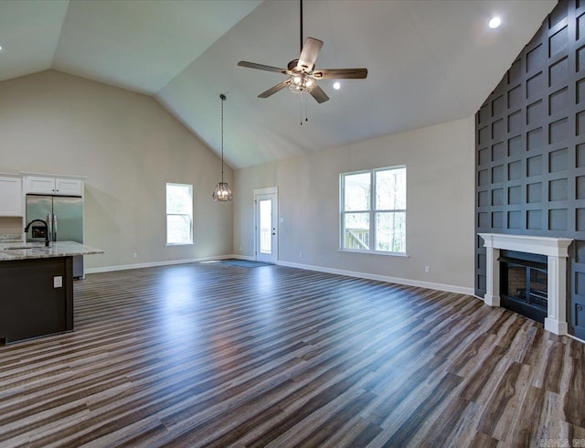 341 Diamondhead Dr, Hot Springs, AR 71913 - unfurnished living room with high vaulted ceiling, dark wood-style flooring, baseboards, and ceiling fan